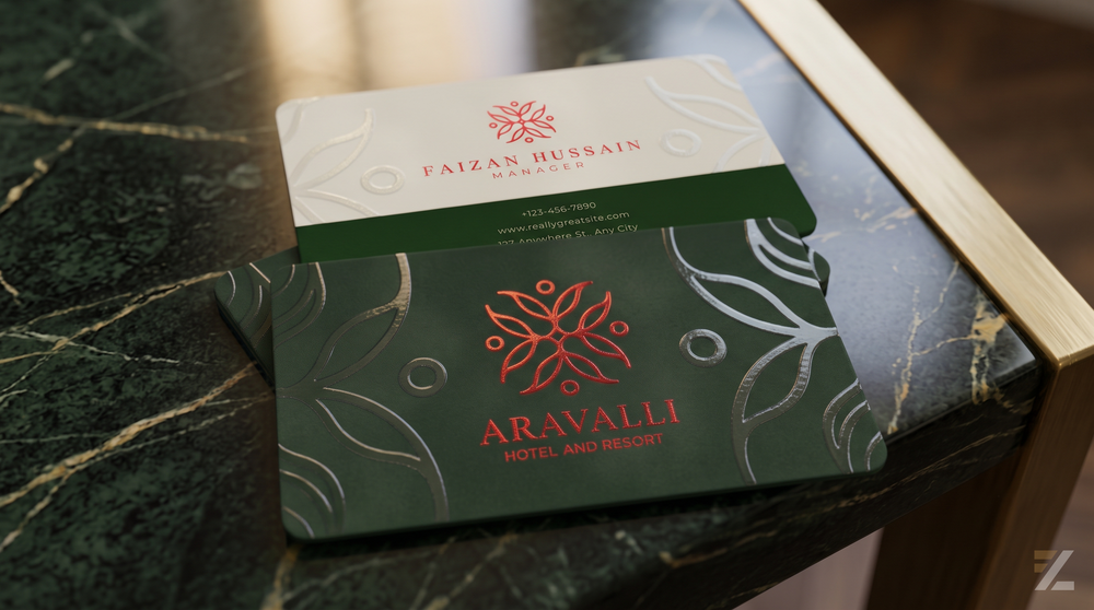 Luxury visiting cards combining red metallic foil logos with glossy Spot UV patterns on deep green and ivory surfaces, displayed on a dark marble tabletop.